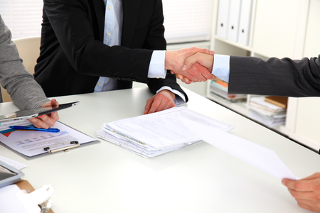 Business people handshake, sitting at the table.の写真素材