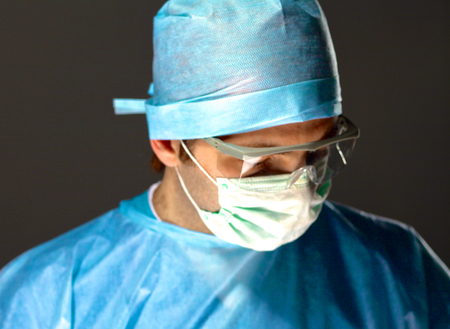 Man surgeon holds a scalpel in an operating room .の写真素材