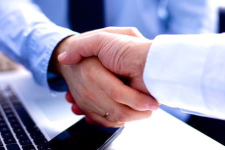 Business meeting at the table shaking hands conclusion of the contract.の写真素材
