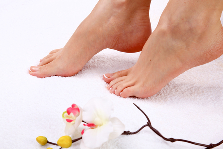 pedicure on legs and beautiful manicure on hands closeup.の写真素材