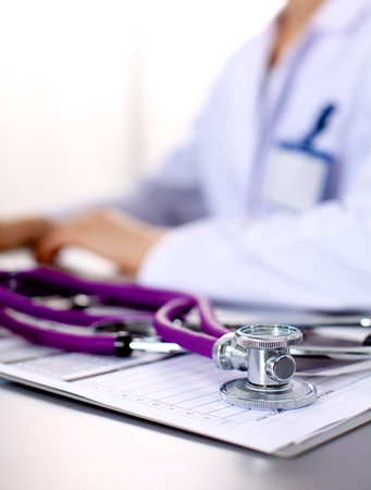 Young doctor at the table is receiving patient.の写真素材