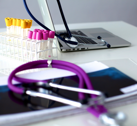 Violet stethoscope on a laptop computer .の写真素材