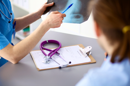doctor with stethoscope on the patient's admission at the table.の写真素材