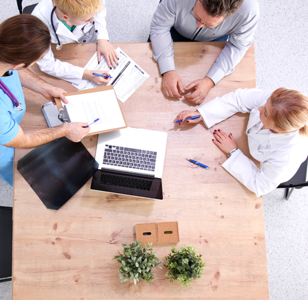 Attractive female doctor shaking a patient's hands in her office.の写真素材