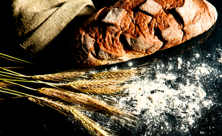 bread and ears are on the old table.の写真素材