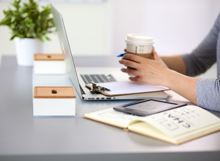 young girl the designer of the table with a laptop.の写真素材
