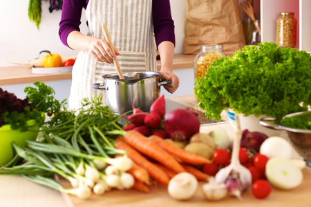 Young Woman Cooking in the kitchen. Healthy Food.の写真素材