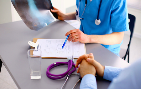 Family doctor spends consultation in the office.の写真素材