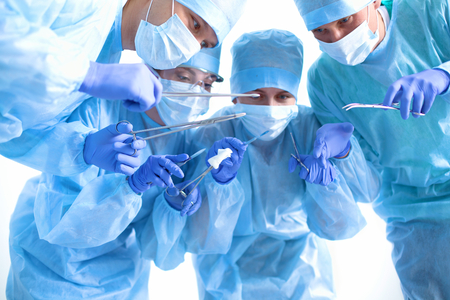 Team of surgeon in uniform perform operation on a patient at cardiac surgery clinic.の写真素材