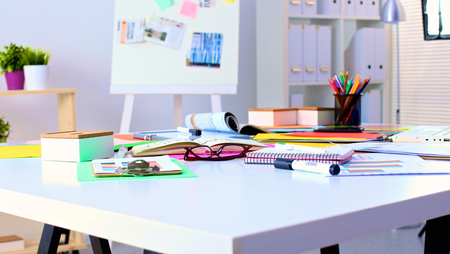 Office table with blank notepad and laptop .の写真素材