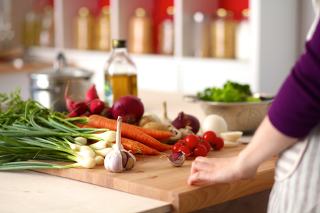 Young Woman Cooking in the kitchen. Healthy Food.の写真素材