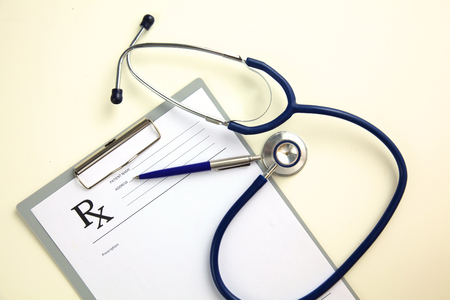 Medical stethoscope and a plate on the table.の写真素材