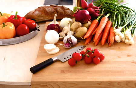 Pile of organic vegetables on a rustic wooden table.の写真素材