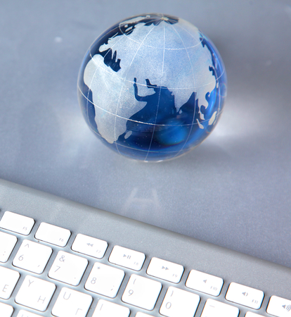 Cristal globe of the Earth on a Computer.の写真素材