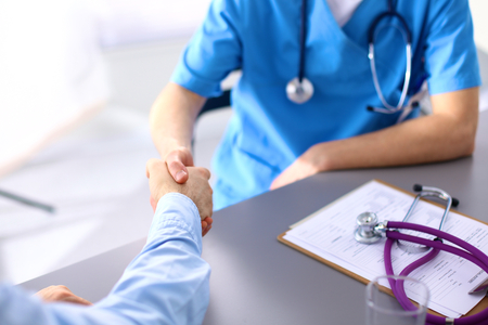 close up of patient and doctor taking notes.の写真素材