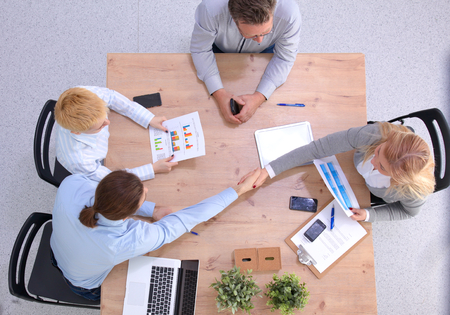 Image of business partners discussing documents and ideas at meeting.の写真素材