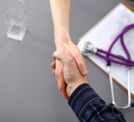 Business handshake. Two businessman shaking hands with each other in the office.の写真素材