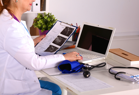 Female doctor at the desk in the office.の写真素材