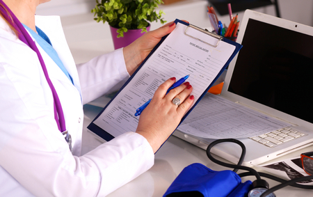 Female doctor at the desk in the office.の写真素材