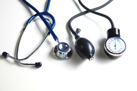 Silver stethoscope lying down on an laptop, toned blue.の写真素材