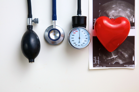 Silver stethoscope lying down on an laptop, toned blue.の写真素材