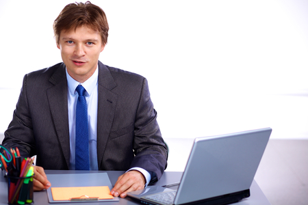 businessman sitting at a desk in the office.の写真素材