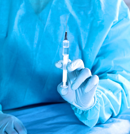 syringe in the hands of the doctor, close-up.の写真素材