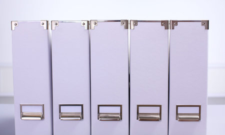 paper folders are on the table in a row.