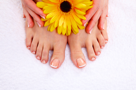 Beautiful feet with perfect spa french nail pedicure .の写真素材
