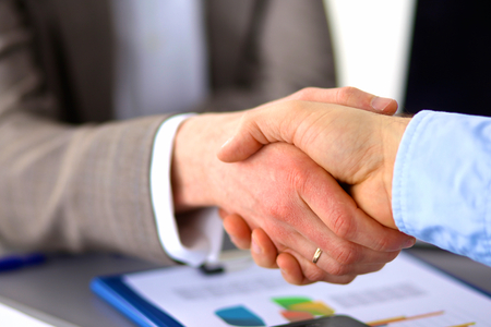 Business meeting at the table shaking hands conclusion of the contract.の写真素材