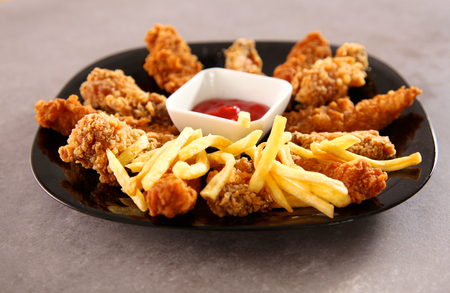 Grilled chicken on a plate standing the wooden tableの写真素材