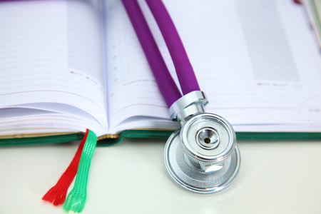 Stethoscope and computer on a desk in the officeの写真素材