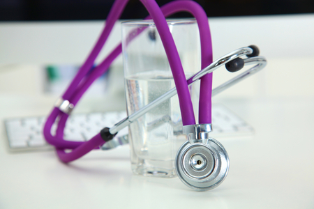 Stethoscope and computer on a desk in the officeの写真素材