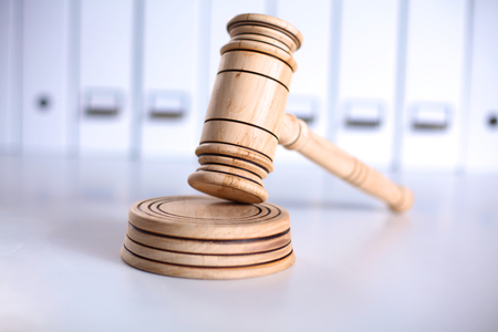 A wooden judge gavel and soundboard isolated on white background in perspectiveの写真素材