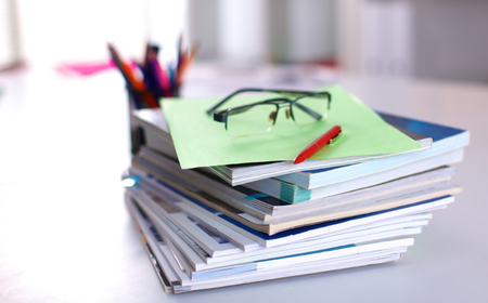 Group of multicolored office folders and glassesの写真素材