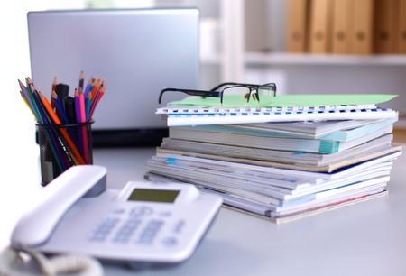 Group of multicolored office folders and glassesの写真素材