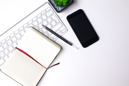 open daily, a computer and a smartphone on the desktop in the officeの写真素材