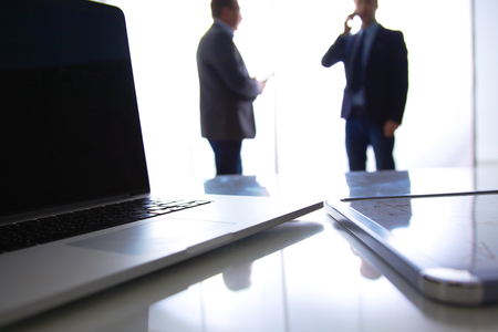 Desktop and tablet on the background of a business teamの写真素材