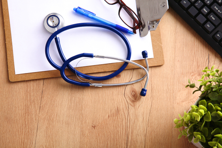 A medical stethoscope lies on the patients medical history on a computer background. The concept of medical care or insuranceの写真素材
