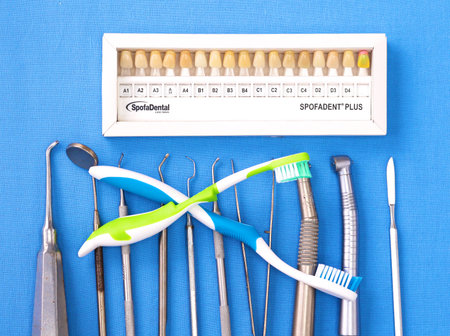 surgical instruments and tools including scalpels, forceps and tweezers arranged on a table for a...
