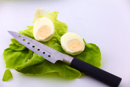 Fresh vegetables with a knife on the table for salad preparationの写真素材