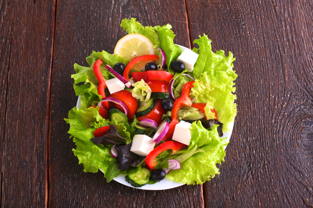 salad from fresh vegetables in a plate on a table, selective focusの写真素材