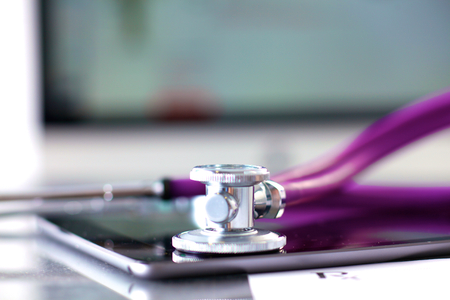 Stethoscope with a tablet computer lie on a tableの写真素材