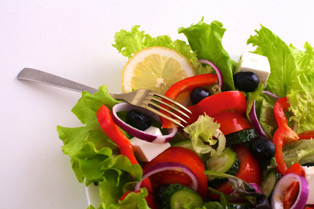 salad from fresh vegetables in a plate on a table, selective focusの写真素材