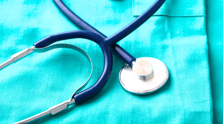 Stethoscope on a background of medical coatの写真素材