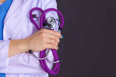 Woman doctor standing with folder at hospital.の写真素材