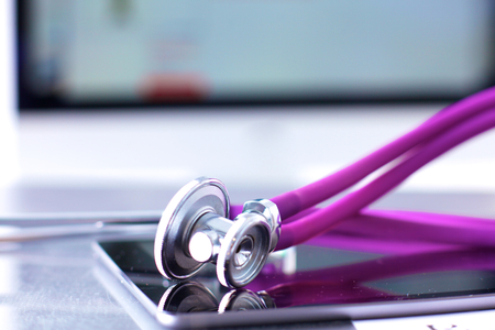 Stethoscope with a tablet computer lie on a tableの写真素材