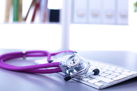 medical stethoscope with a computer on the deskの写真素材