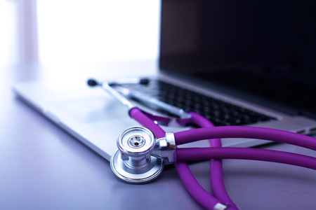 medical stethoscope with a computer on the deskの写真素材