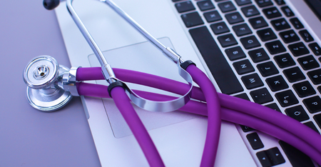 medical stethoscope with a computer on the deskの写真素材